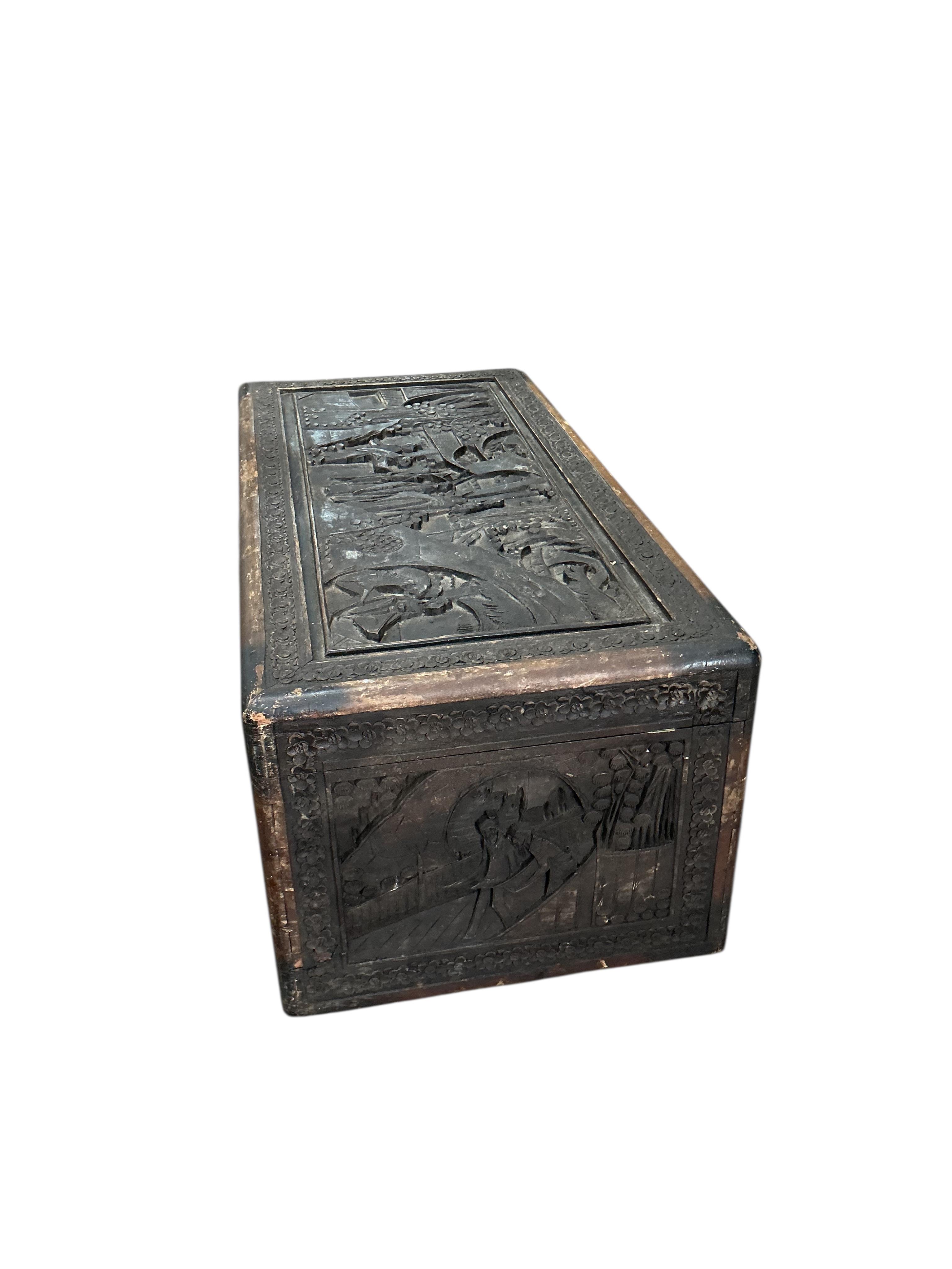 A Chinese carved camphor wood trunk, width 90cm, depth 44cm, height 36cm